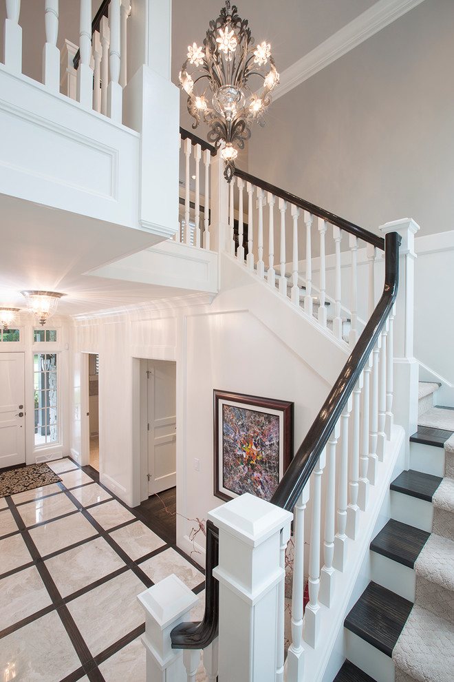Transitional marble floor foyer photo in Omaha with white walls and a white front door