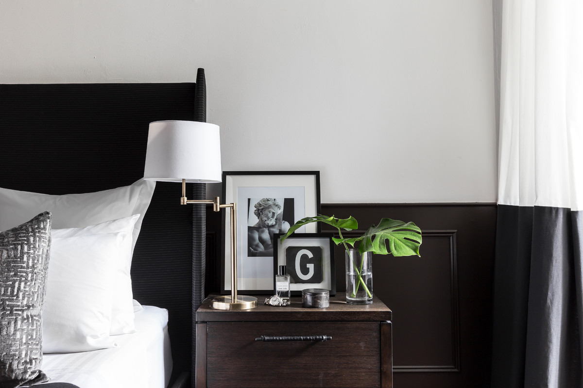 Inspiration for a small contemporary master bedroom in Sydney with white walls, dark hardwood floors and brown floor.