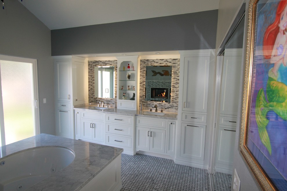 Design ideas for a large transitional master bathroom in Los Angeles with an undermount sink, shaker cabinets, white cabinets, marble benchtops, an undermount tub, a curbless shower, a one-piece toilet, white tile, grey walls and mosaic tile floors.