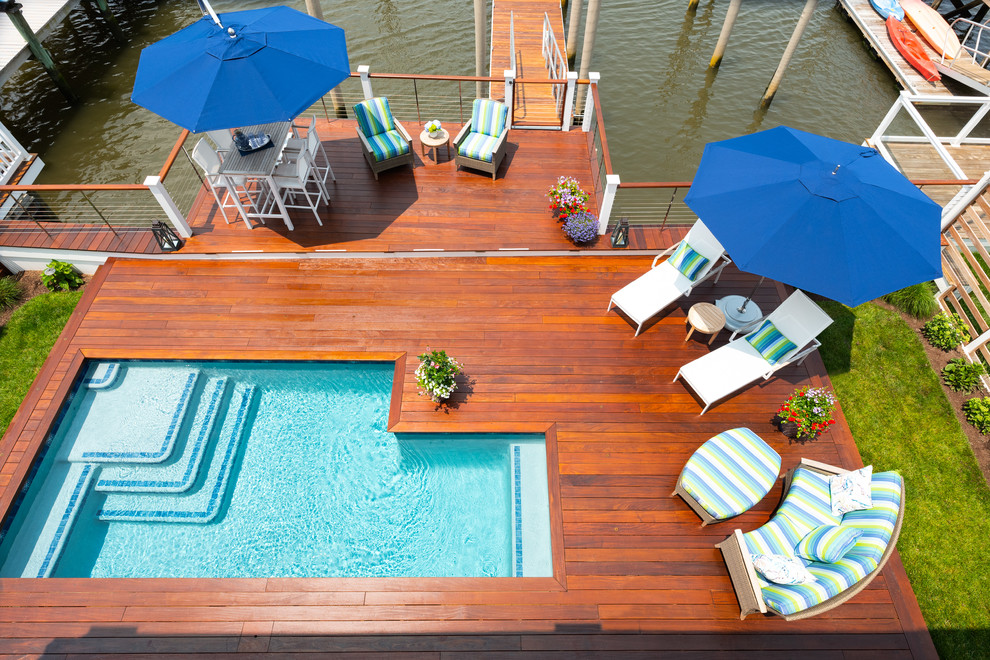 Design ideas for a mid-sized beach style l-shaped pool in Philadelphia with decking.