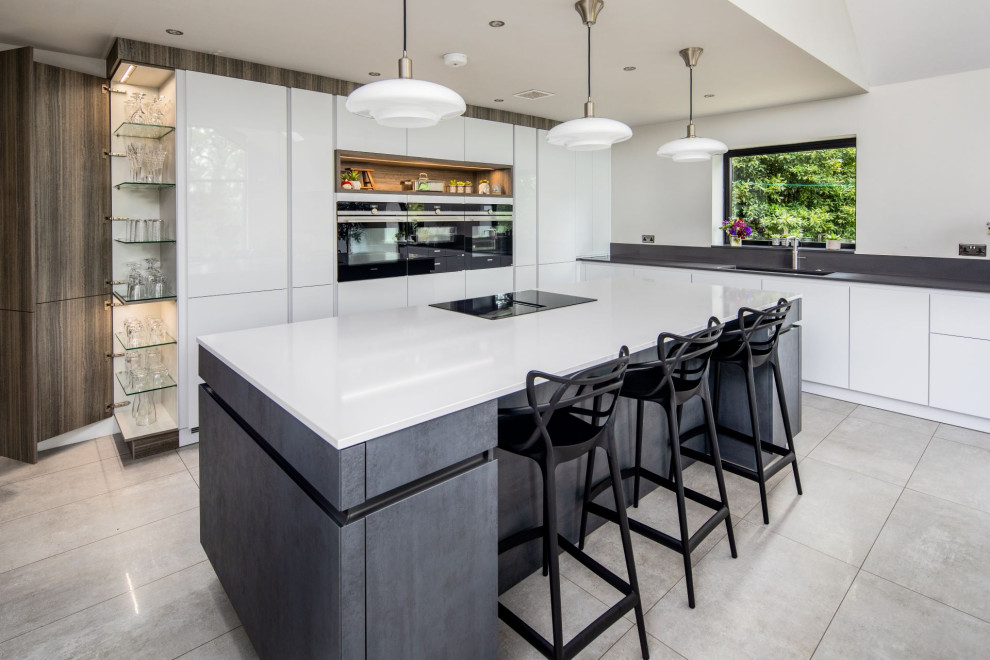 Photo of a large contemporary l-shaped eat-in kitchen in Other with a double-bowl sink, flat-panel cabinets, white cabinets, quartzite benchtops, grey splashback, engineered quartz splashback, panelled appliances, with island and white benchtop.