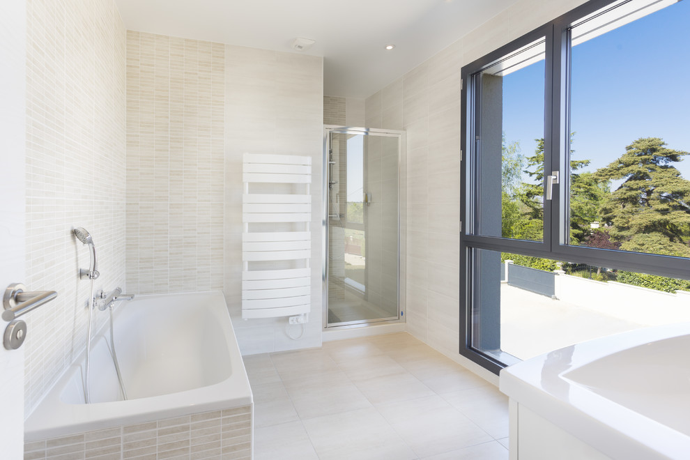 Photo of a large modern master bathroom in Paris with beige tile, ceramic tile, beige walls, ceramic floors, a console sink, beige floor and a hinged shower door.