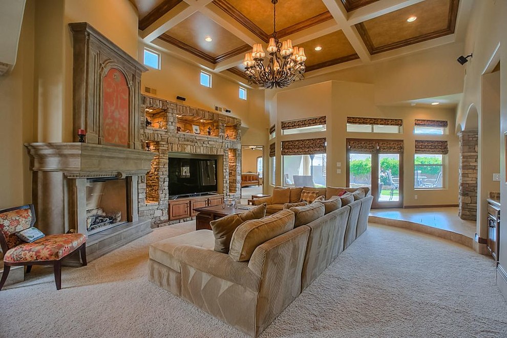 Inspiration for a large formal open concept living room in Albuquerque with beige walls, limestone floors, a standard fireplace, a stone fireplace surround and a built-in media wall.