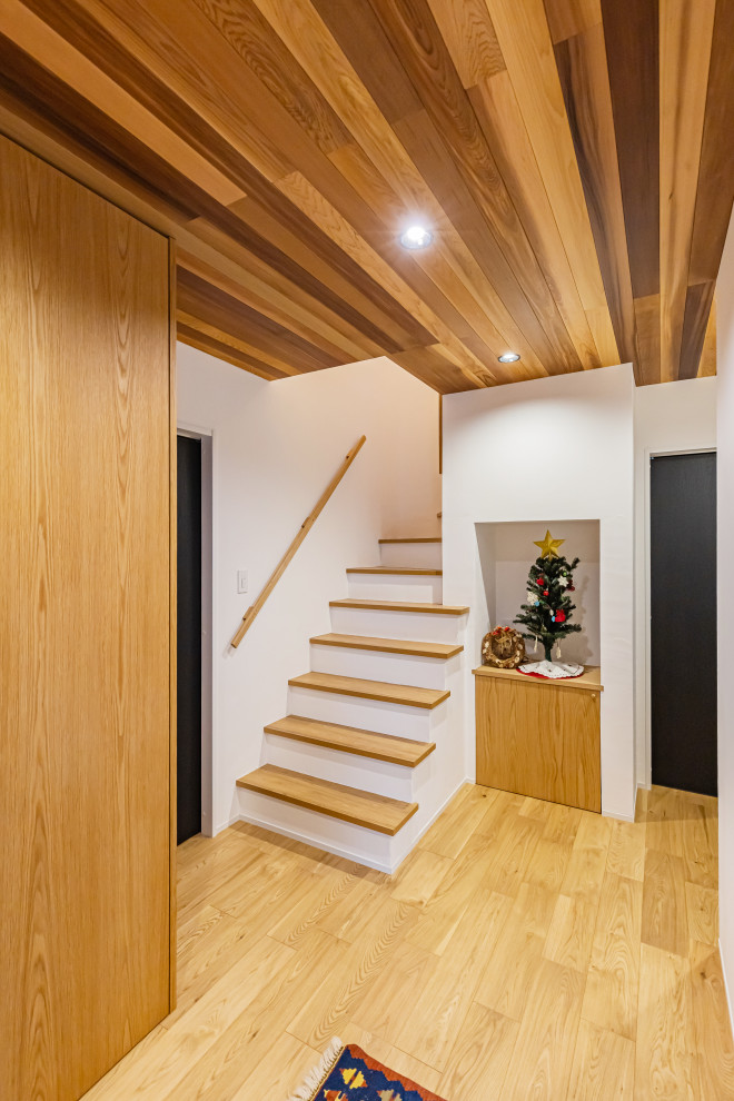 Réalisation d'une entrée minimaliste de taille moyenne avec un couloir, une porte simple et un plafond en bois.