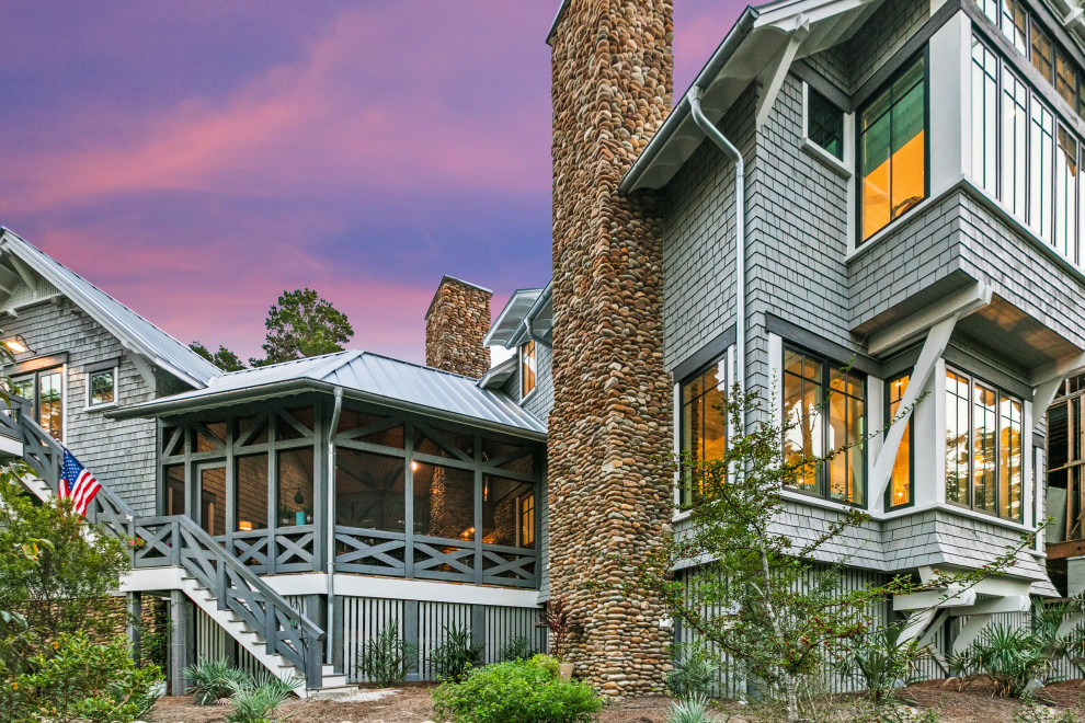 Example of a mid-sized mountain style gray two-story wood and shingle gable roof design with a metal roof and a gray roof