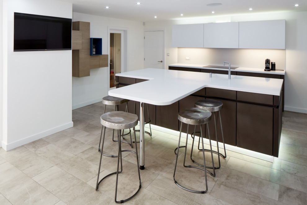 Photo of a medium sized contemporary kitchen/diner in Other with an integrated sink, flat-panel cabinets, brown cabinets, composite countertops, grey splashback, glass sheet splashback, integrated appliances, an island and white worktops.