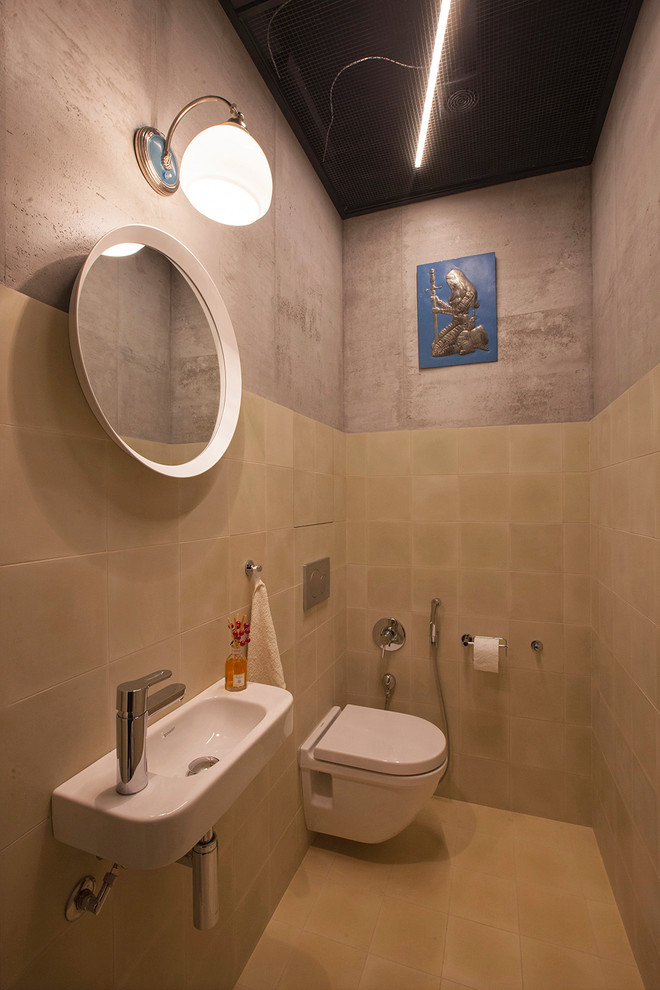 Inspiration for a contemporary powder room in Moscow with a wall-mount toilet, beige tile, beige walls and a wall-mount sink.