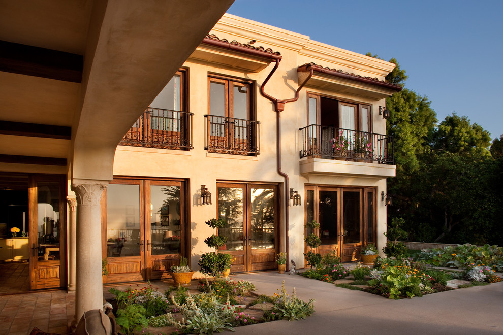 This is an example of a large mediterranean two-storey stucco beige exterior in San Diego.