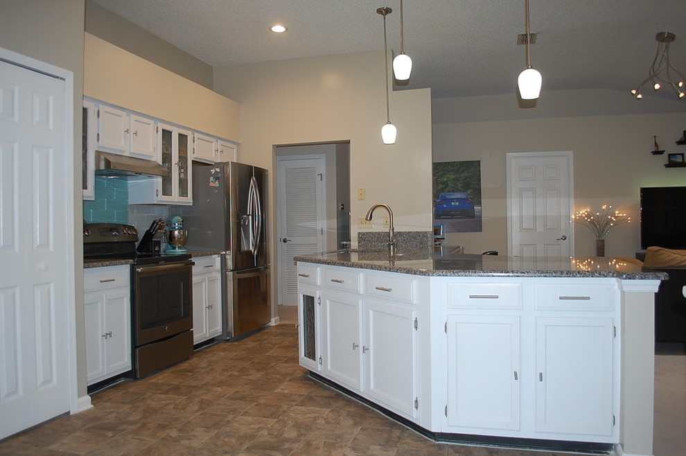 Kitchen - transitional u-shaped kitchen idea in Jacksonville with shaker cabinets, white cabinets and granite countertops