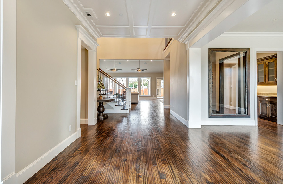 This is an example of a mid-sized transitional foyer in Dallas with medium hardwood floors, a single front door and a medium wood front door.