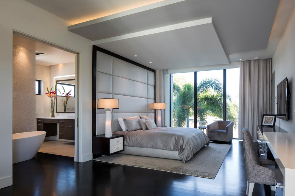 Design ideas for a large contemporary master bedroom in Orlando with dark hardwood floors, brown floor and white walls.