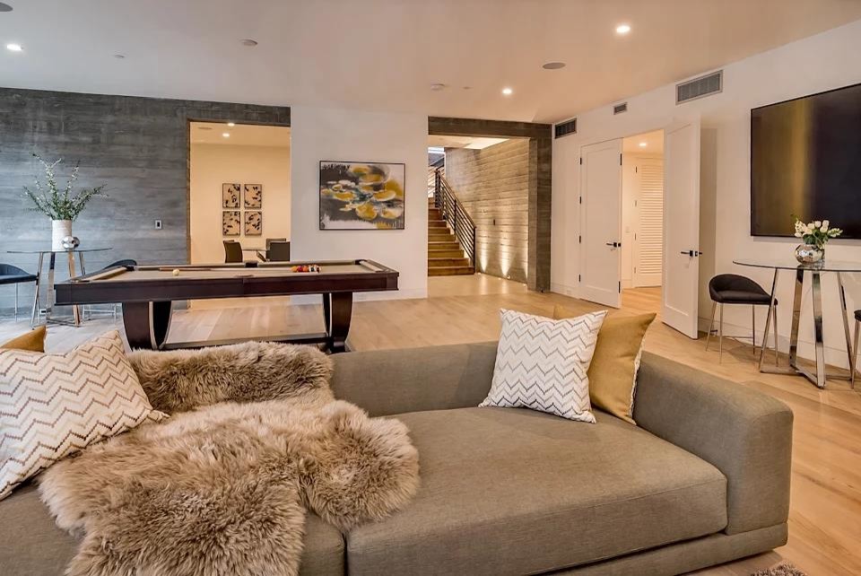 Inspiration for a large modern walk-out basement in San Francisco with grey walls, porcelain floors, no fireplace and beige floor.