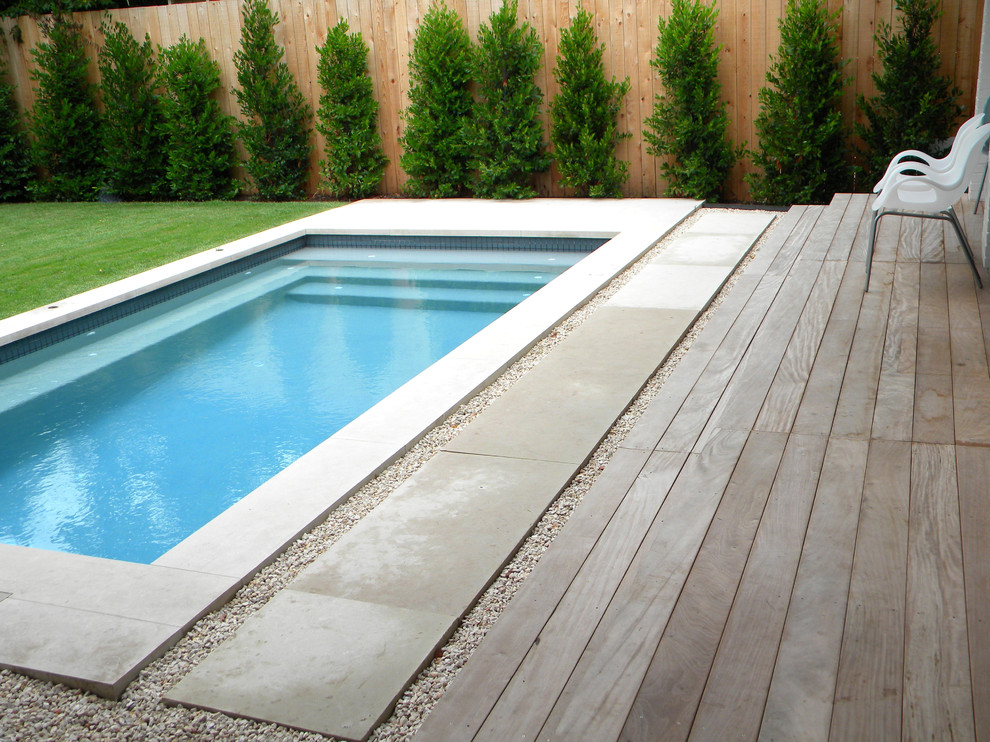 Design ideas for a modern rectangular pool in Austin with concrete pavers.