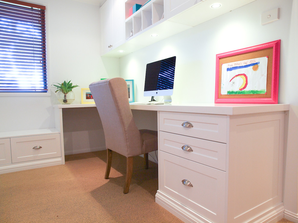 Photo of a mid-sized traditional study room in Wollongong with white walls, carpet and a built-in desk.