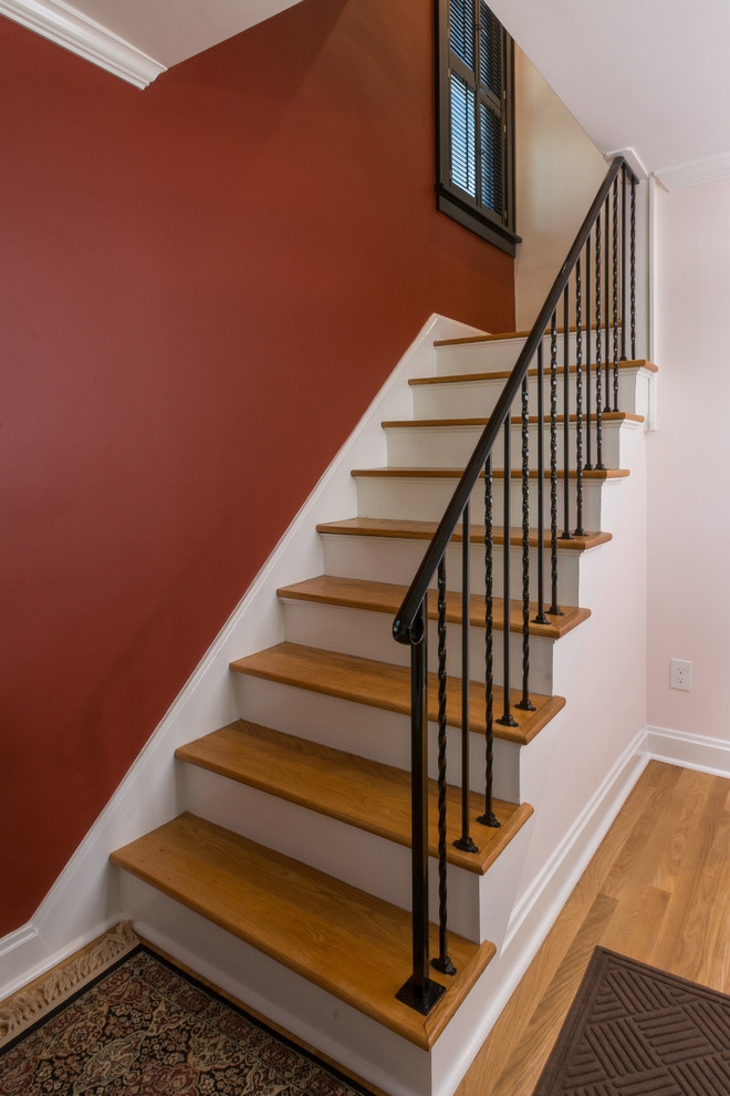This is an example of a mid-sized traditional wood straight staircase in Columbus with wood risers.