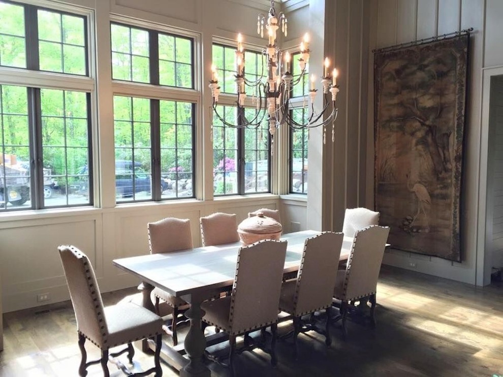 Photo of a mid-sized contemporary separate dining room in Charlotte with white walls, light hardwood floors and beige floor.