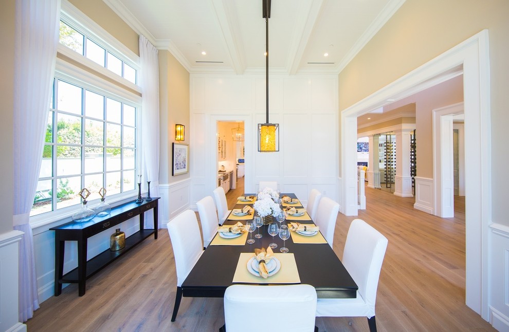 Large transitional dining room in Los Angeles with beige walls, light hardwood floors and no fireplace.