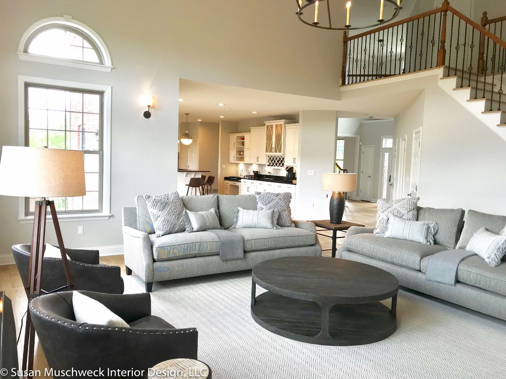 Large transitional open concept light wood floor home design photo with white walls