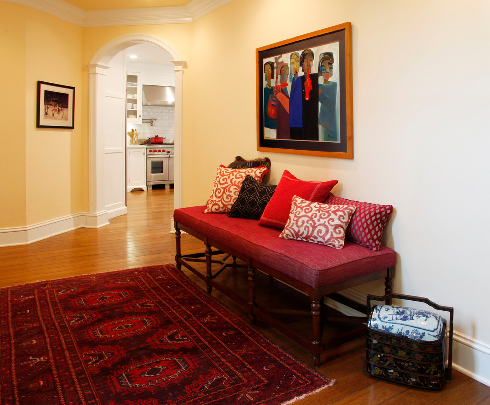 Inspiration for a large eclectic entry hall in San Francisco with yellow walls and medium hardwood floors.