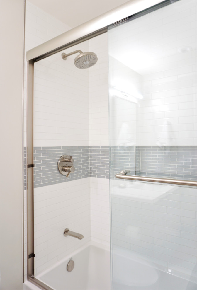 Design ideas for a mid-sized contemporary bathroom in San Francisco with flat-panel cabinets, grey cabinets, an alcove tub, a shower/bathtub combo, a one-piece toilet, white tile, subway tile, white walls, wood-look tile, an undermount sink, engineered quartz benchtops, beige floor, a sliding shower screen, white benchtops, a niche, a single vanity and a built-in vanity.