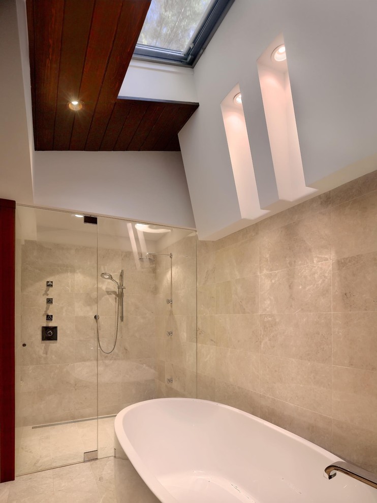Photo of a mid-sized contemporary master bathroom in Atlanta with flat-panel cabinets, dark wood cabinets, a freestanding tub, an alcove shower, beige tile, travertine, beige walls, light hardwood floors, an integrated sink, stainless steel benchtops, brown floor and a hinged shower door.