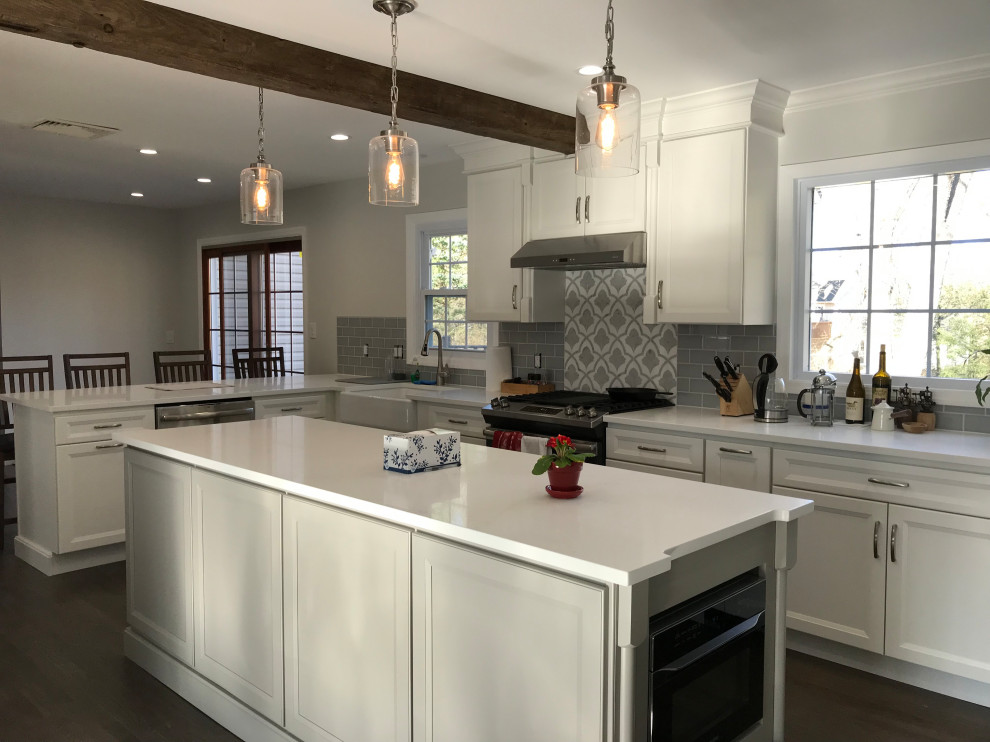 Eat-in kitchen - large transitional u-shaped ceramic tile and gray floor eat-in kitchen idea with a farmhouse sink, recessed-panel cabinets, white cabinets, quartz countertops, gray backsplash, subway tile backsplash, stainless steel appliances, an island and white countertops