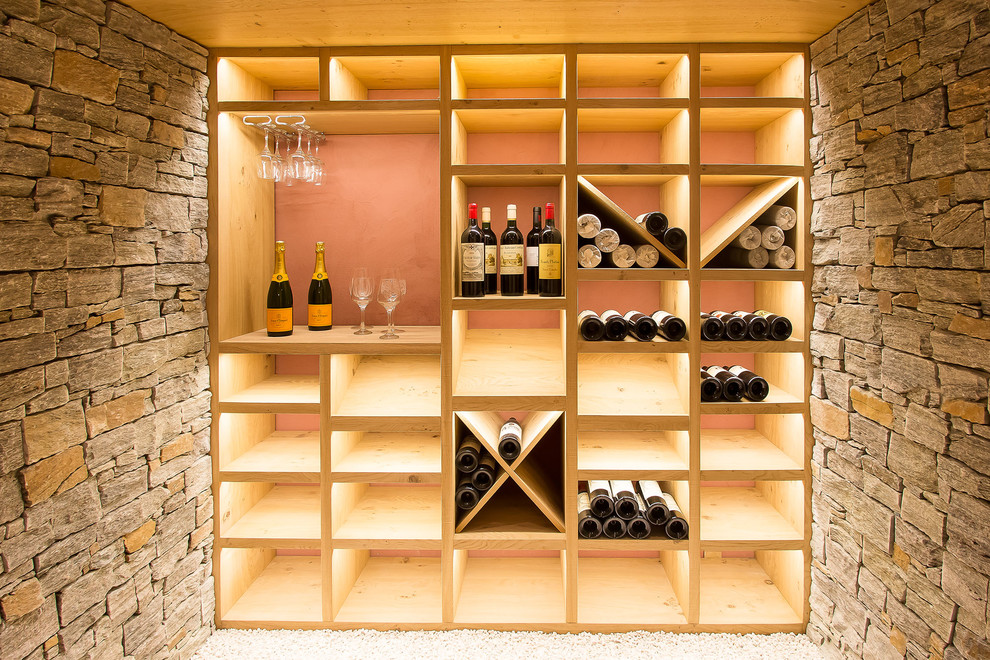 Mid-sized contemporary wine cellar in Lyon with storage racks.