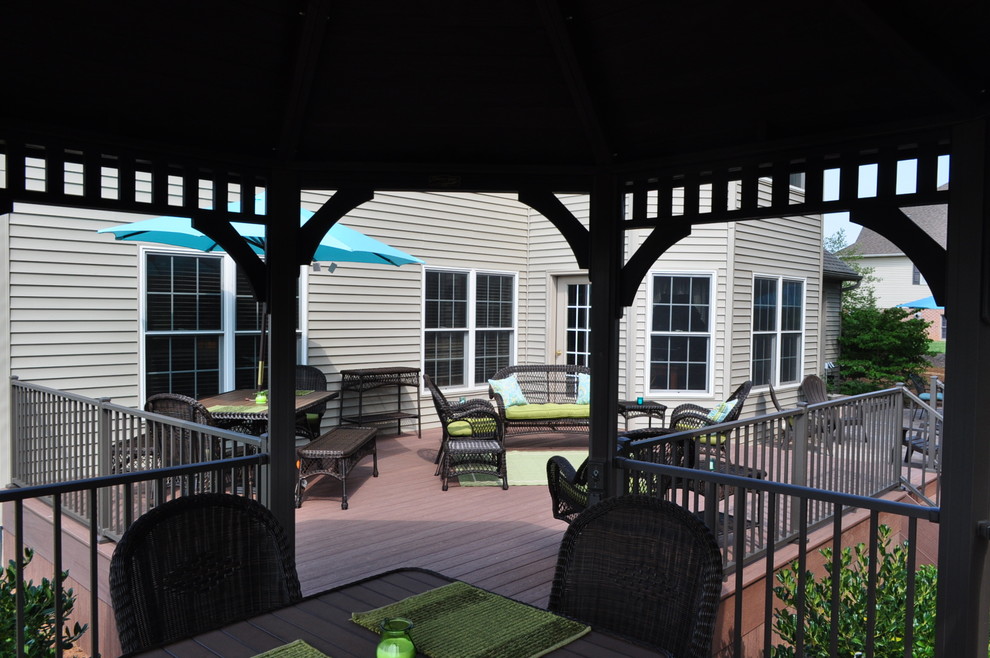 Deck - mid-sized transitional backyard deck idea with a pergola