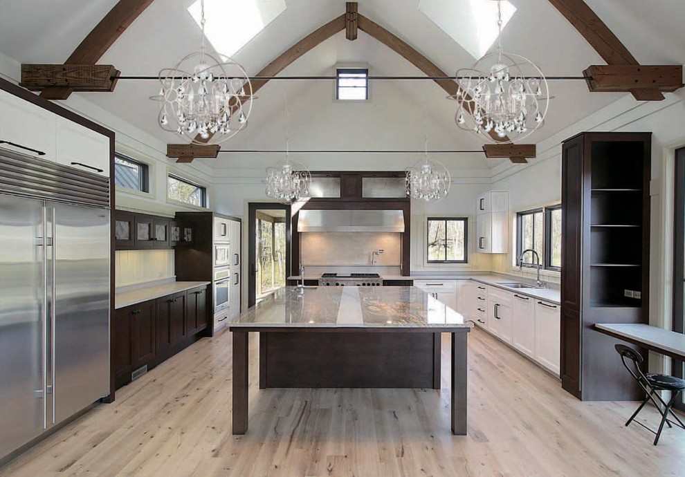 Large minimalist u-shaped light wood floor and beige floor open concept kitchen photo with an undermount sink, shaker cabinets, dark wood cabinets, granite countertops, white backsplash, stainless steel appliances, an island and multicolored countertops