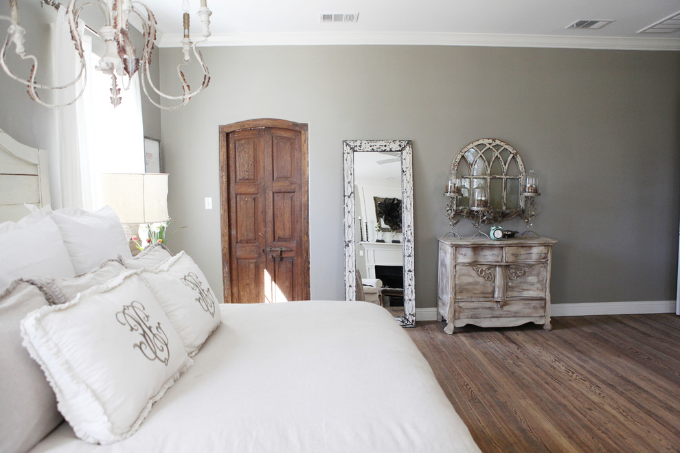 Design ideas for a small country master bedroom in Austin with grey walls, medium hardwood floors and no fireplace.