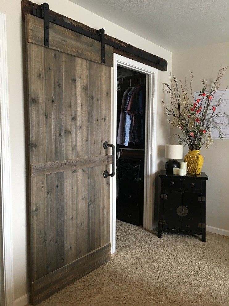 Mid-sized mountain style master carpeted and beige floor bedroom photo with white walls and no fireplace