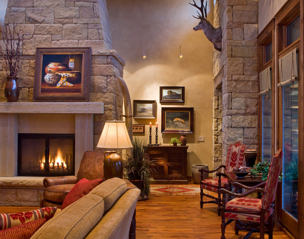 Inspiration for a country living room in Austin with a standard fireplace and a stone fireplace surround.