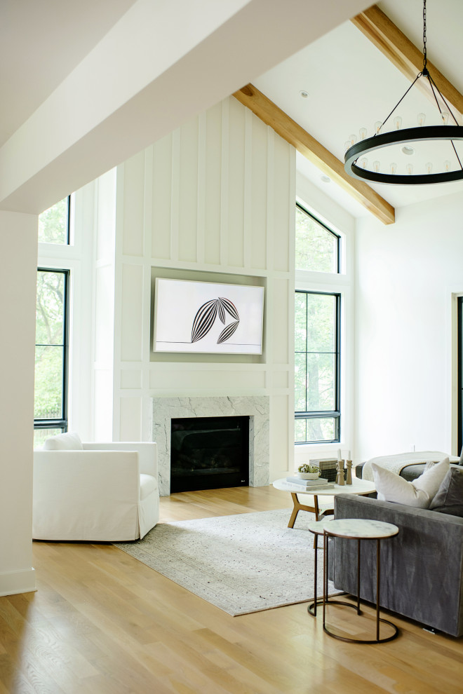 Photo of a contemporary living room in Cincinnati with white walls, light hardwood floors, a standard fireplace, a stone fireplace surround, a wall-mounted tv, exposed beam and decorative wall panelling.