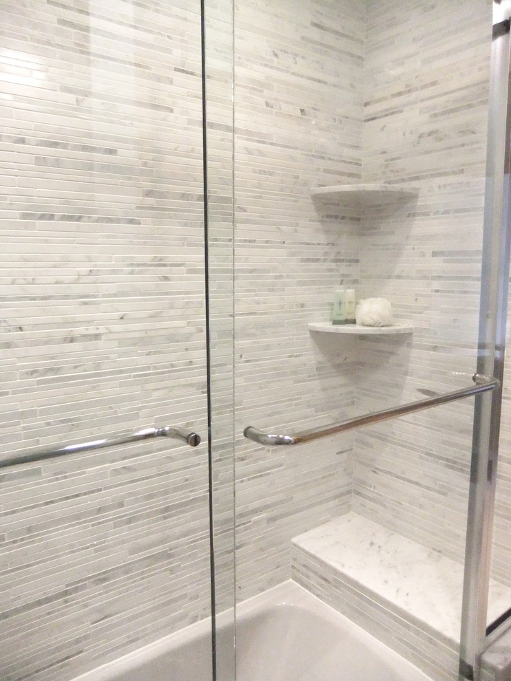 This is an example of a small transitional bathroom in Columbus with an alcove tub, a shower/bathtub combo, a two-piece toilet, gray tile, mosaic tile, blue walls and porcelain floors.