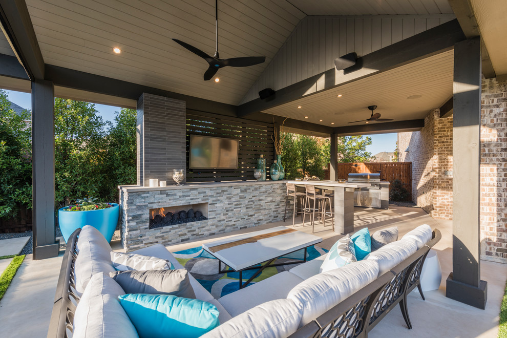 Inspiration for a large transitional backyard patio in Dallas with concrete slab, a fire feature and a roof extension.