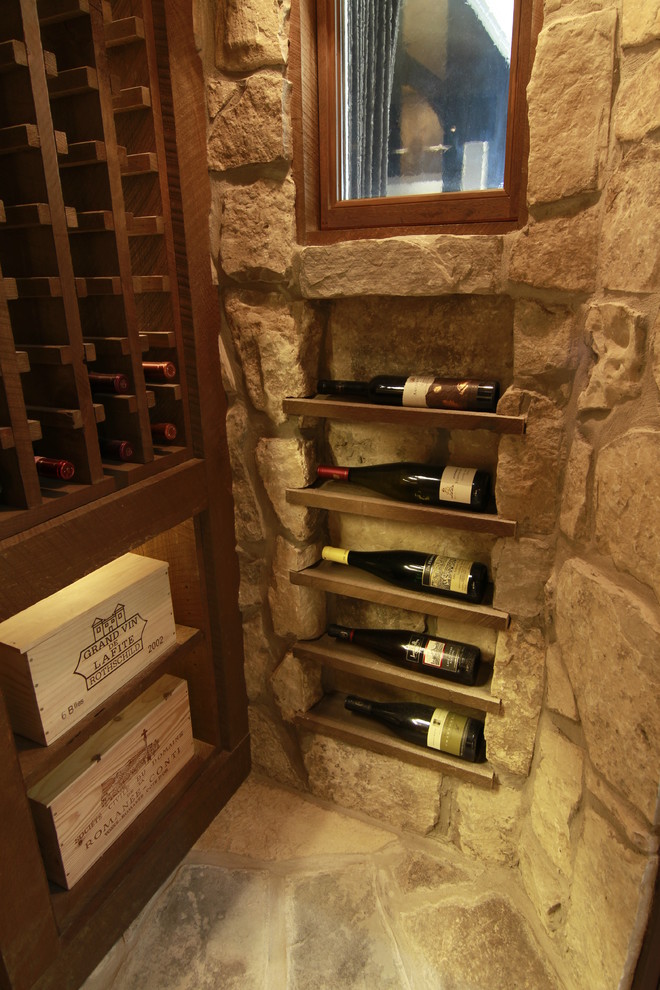 Mid-sized country wine cellar in Toronto with slate floors and storage racks.