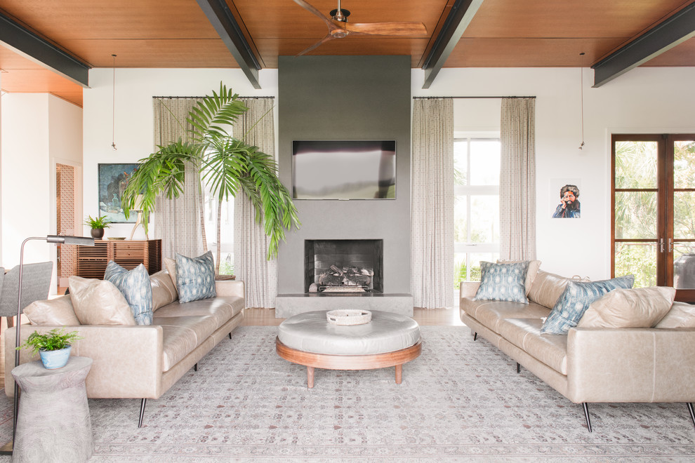 Beach style open concept family room in Charleston with white walls, a standard fireplace and a wall-mounted tv.