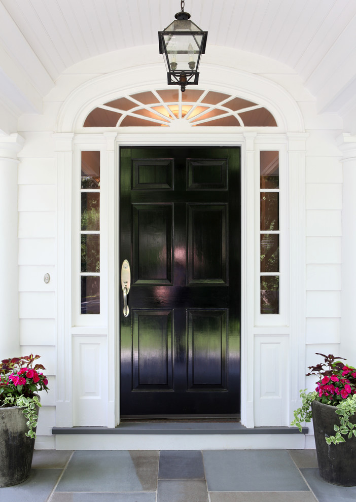Photo of a large traditional front door in Other with white walls, slate floors, a single front door, a black front door and blue floor.