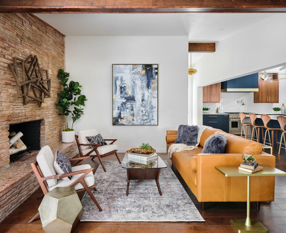 Mid-sized mid-century modern open concept medium tone wood floor, brown floor and exposed beam living room photo in Austin with white walls, a standard fireplace and a stacked stone fireplace