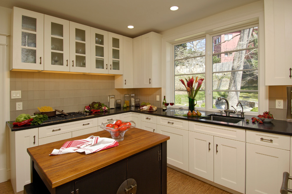 Inspiration for a mid-sized transitional u-shaped light wood floor and beige floor eat-in kitchen remodel in DC Metro with an undermount sink, shaker cabinets, white cabinets, granite countertops, green backsplash, glass tile backsplash, white appliances and an island