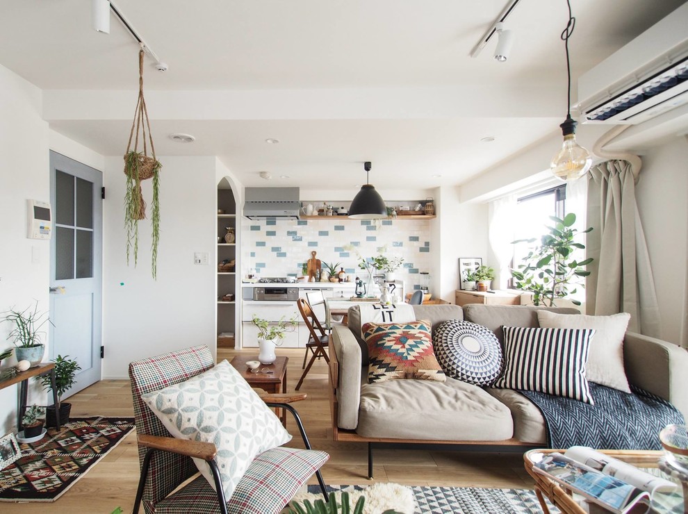 Photo of a scandinavian open concept living room in Tokyo with multi-coloured walls, medium hardwood floors and beige floor.