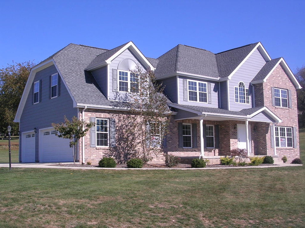 Inspiration for a large transitional multicolored two-story mixed siding gable roof remodel with a shingle roof