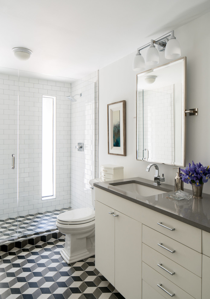 Mid-sized transitional 3/4 white tile and subway tile ceramic tile and multicolored floor bathroom photo in Denver with a hinged shower door, flat-panel cabinets, white cabinets, a two-piece toilet, white walls, a drop-in sink and gray countertops