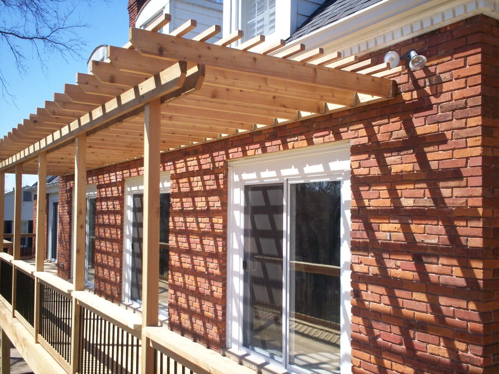 Inspiration for a rustic backyard deck remodel in St Louis with a pergola