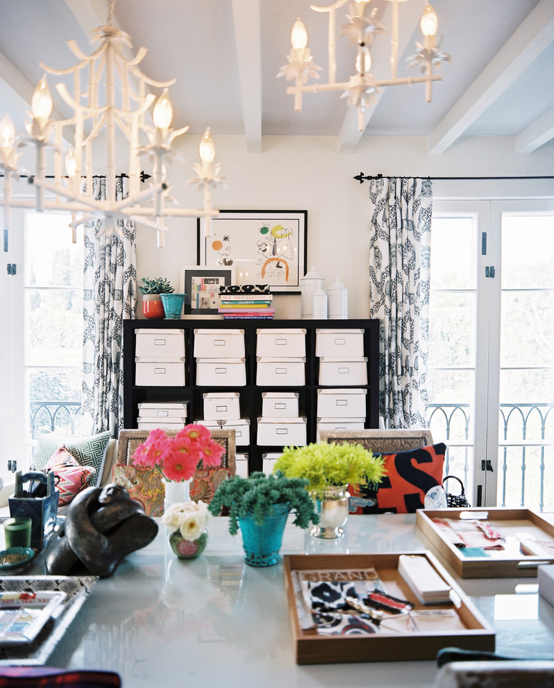 This is an example of an eclectic home office in Los Angeles with white walls.