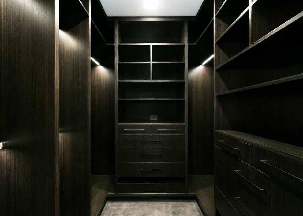 Inspiration for a mid-sized transitional gender-neutral dressing room remodel in DC Metro with flat-panel cabinets and dark wood cabinets