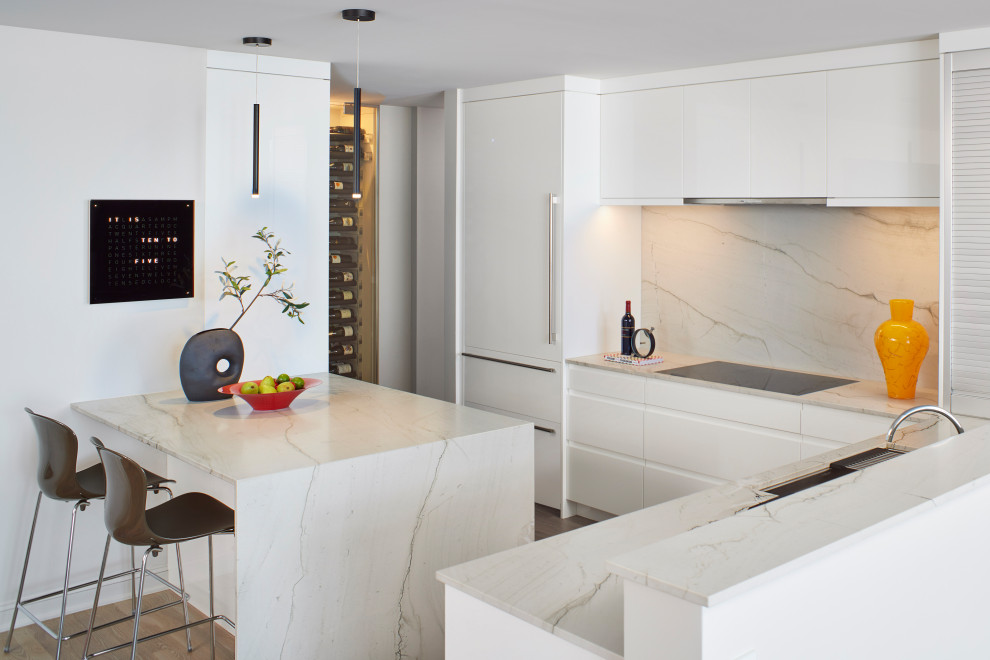Inspiration for a mid-sized contemporary l-shaped open plan kitchen in Denver with an undermount sink, flat-panel cabinets, yellow cabinets, quartzite benchtops, white splashback, stone slab splashback, panelled appliances, light hardwood floors, a peninsula, beige floor and white benchtop.