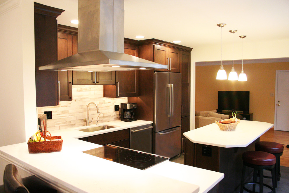 Example of a mid-sized transitional l-shaped porcelain tile eat-in kitchen design in DC Metro with an undermount sink, flat-panel cabinets, dark wood cabinets, quartzite countertops, gray backsplash, stone tile backsplash, stainless steel appliances and an island
