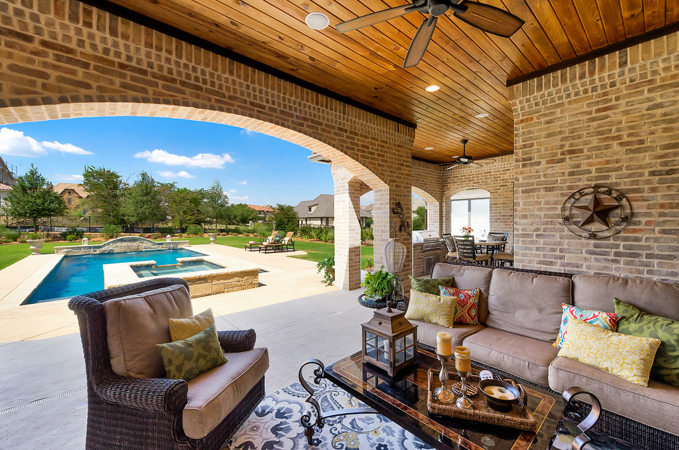 Traditional backyard patio in Dallas with tile and a roof extension.