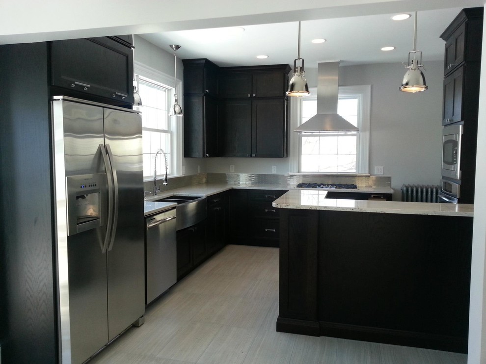 Eat-in kitchen - mid-sized transitional l-shaped porcelain tile and gray floor eat-in kitchen idea with a farmhouse sink, shaker cabinets, black cabinets, granite countertops, gray backsplash, metal backsplash, stainless steel appliances, an island and white countertops